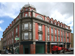 Conversion of the top three floors to living space (30 residential units) and renewal of all shop fronts. 